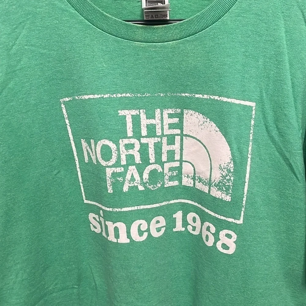 The North Face- green shirt with cream logo on front